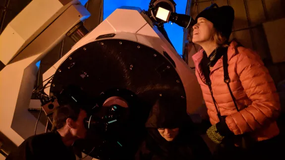 People looking through a telescope