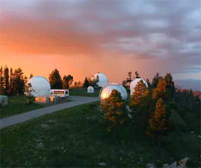 Photo of Mount Lemmon SkyCenter with sunset behind it 